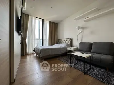 Modern bedroom with cozy bed and stylish sofa in a bright apartment