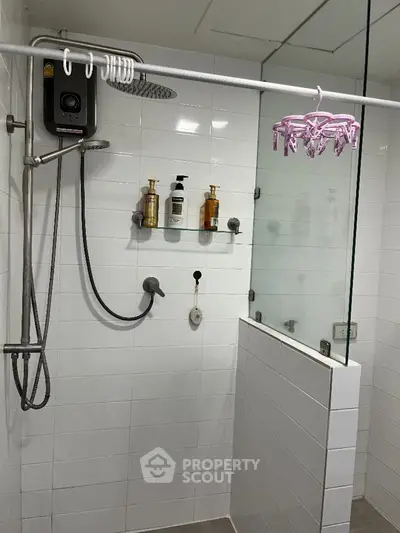 Modern bathroom with glass shower enclosure and sleek fixtures