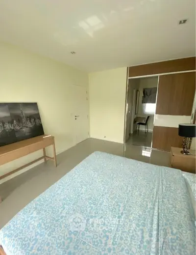 Spacious bedroom with modern decor and ample natural light