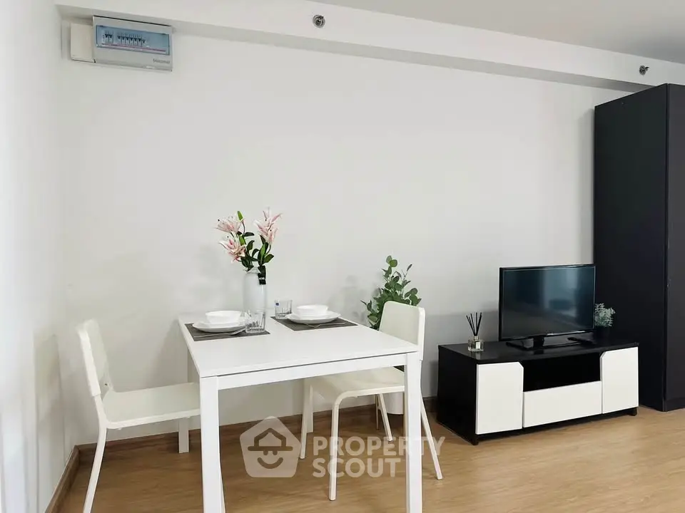 Modern minimalist living room with dining area and TV setup
