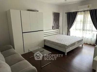 Spacious bedroom with modern furniture and natural light