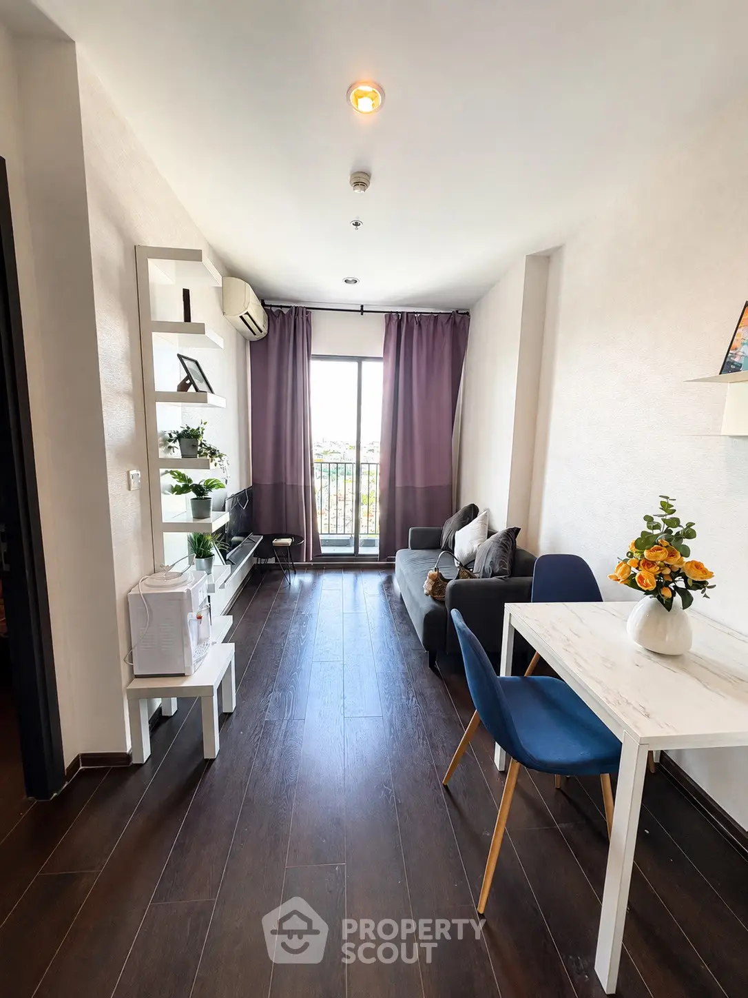 Modern living room with balcony access, featuring sleek furniture and stylish decor.