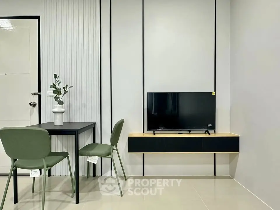 Modern minimalist living room with sleek TV setup and stylish dining area.