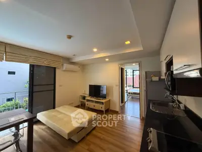 Modern living room with open kitchen and balcony view in stylish apartment