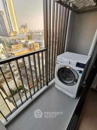 High-rise apartment balcony with city view and washing machine