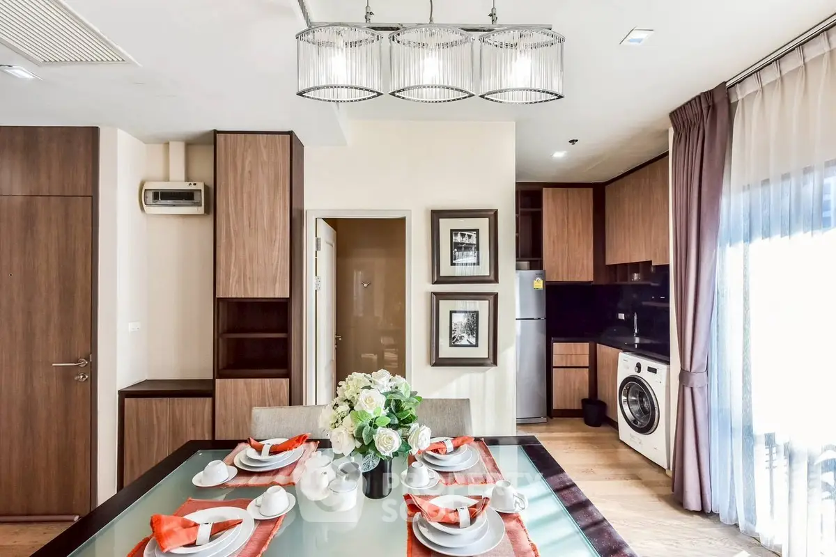 Modern kitchen with dining area, featuring elegant decor and built-in appliances.