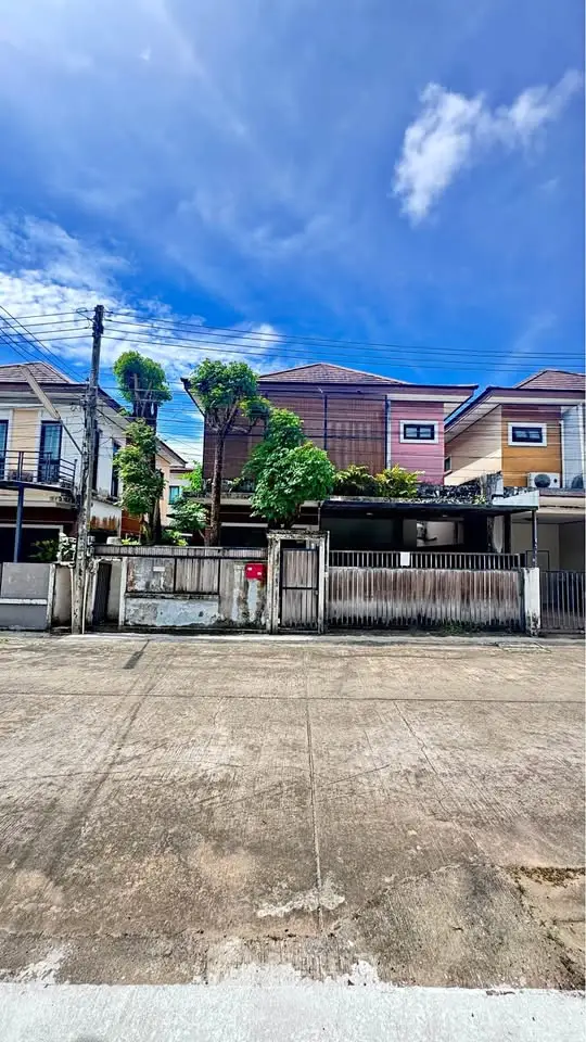 Charming suburban house with lush greenery and clear blue sky