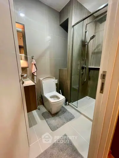 Modern bathroom with sleek design, glass shower, and contemporary fixtures.