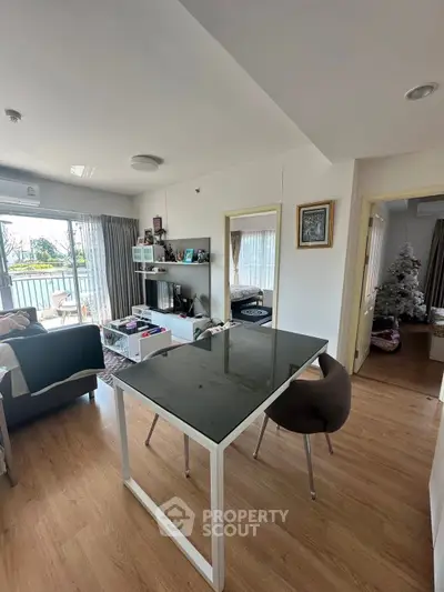 Spacious living room with modern decor and large windows offering natural light.