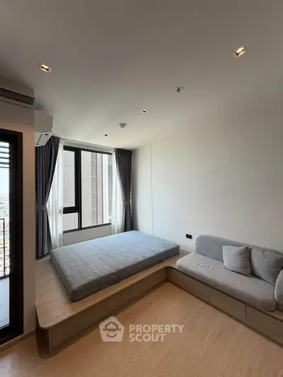 Modern minimalist bedroom with platform bed and city view