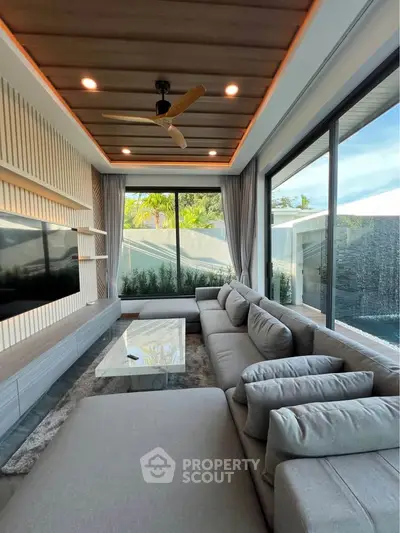 Luxurious modern living room with large windows and stylish decor