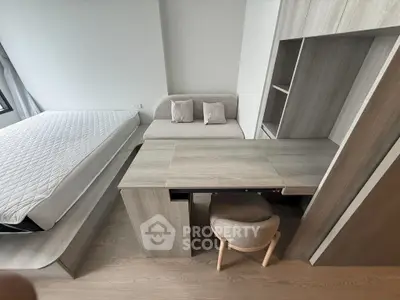 Modern bedroom with sleek wooden furniture and cozy seating area
