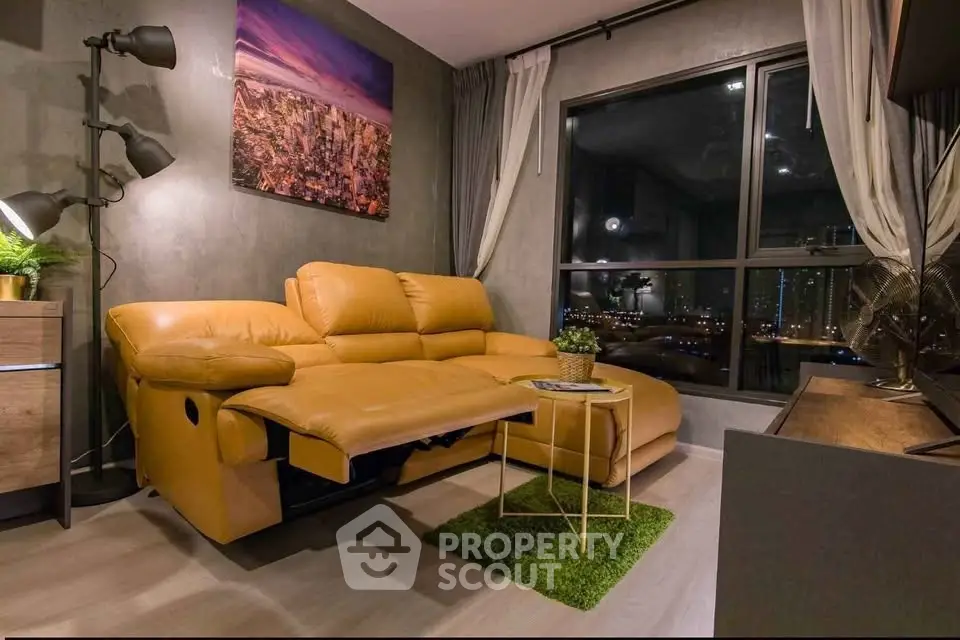 Modern living room with city view, featuring a stylish yellow sofa and chic decor.
