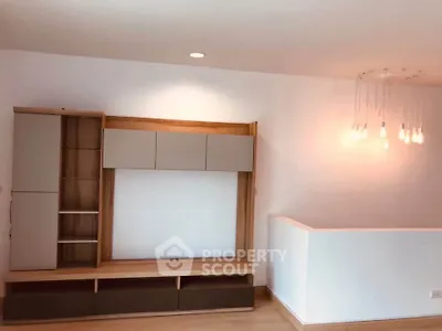 Modern living room with sleek wooden shelving and stylish lighting, perfect for contemporary living.
