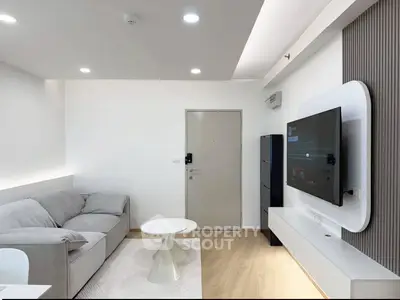 Modern living room with sleek furniture and wall-mounted TV, perfect for contemporary urban living.