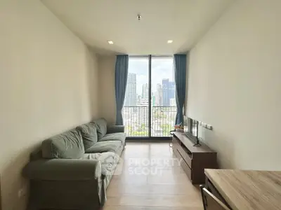 Modern living room with city view, featuring a cozy sofa and sleek TV stand, perfect for urban living.