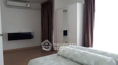 Modern bedroom with air conditioning and stylish curtains in a cozy apartment.