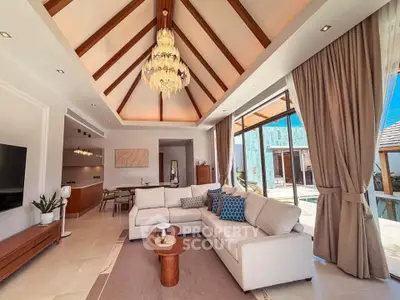 Luxurious living room with high ceilings, elegant chandelier, and pool view in modern villa.