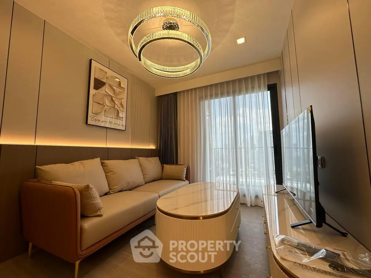 Luxurious living room with modern chandelier and elegant decor in a high-end apartment.