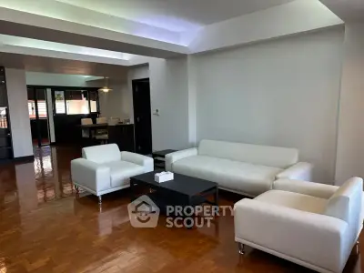 Spacious living room with modern white sofas and wooden flooring
