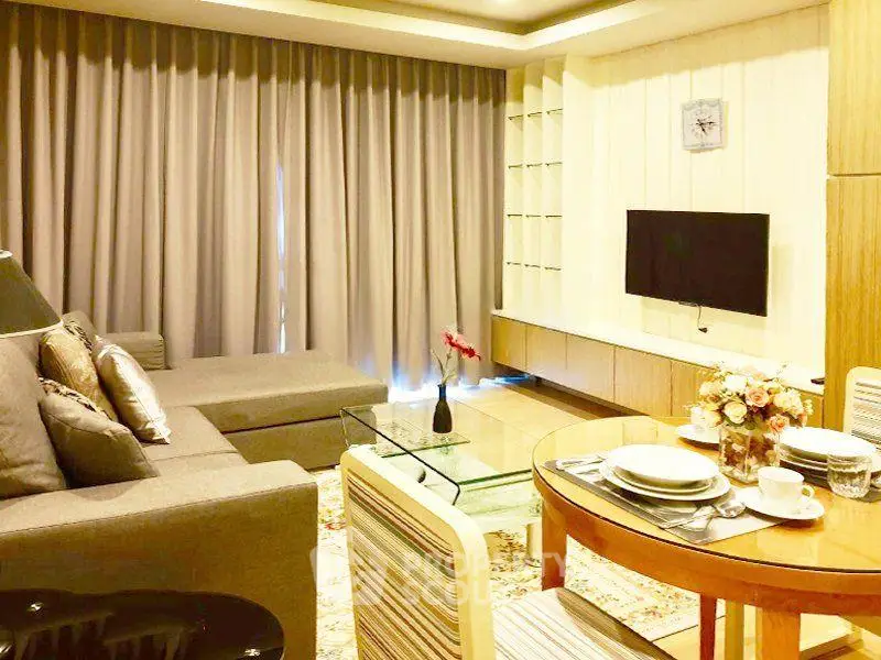 Elegant living room with modern decor, cozy sofa, and dining area in a stylish apartment.