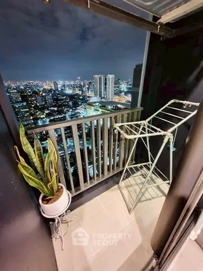 Stunning city view from a modern balcony with railing and plant decor.