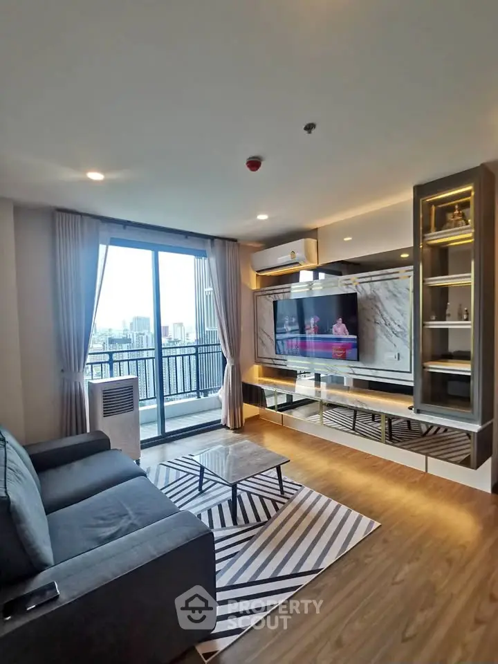 Modern living room with city view, stylish decor, and large balcony access.