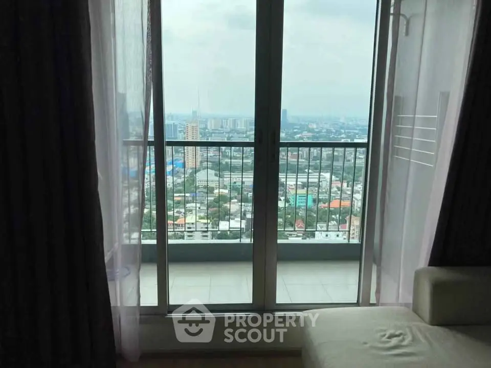 Stunning high-rise apartment with panoramic city view from the balcony, perfect for urban living.