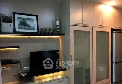 Modern living room with sleek cabinetry and built-in TV unit