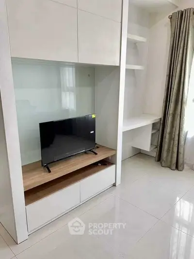 Modern living room with sleek TV unit and built-in shelves, perfect for minimalist design enthusiasts.