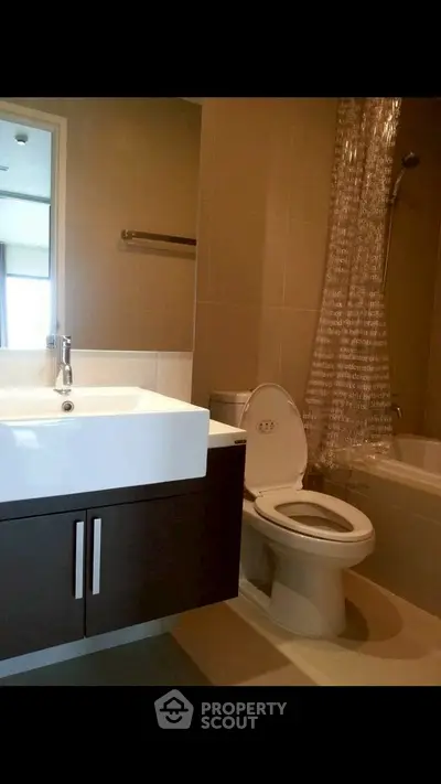 Modern bathroom with sleek fixtures and bathtub in contemporary apartment.
