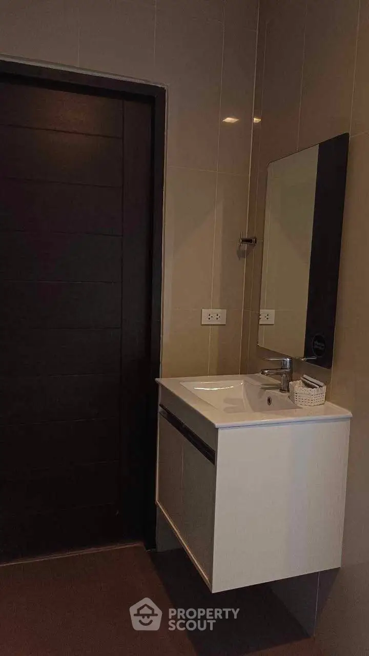 Modern bathroom with sleek vanity and mirror, ideal for contemporary living.