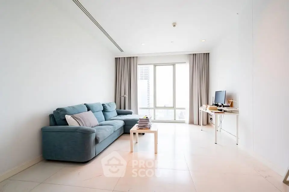 Spacious modern living room with large windows and stylish furniture