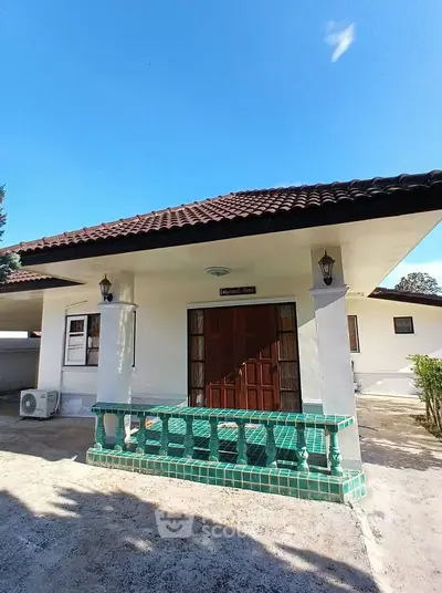 Charming single-story home with tiled roof and inviting entrance