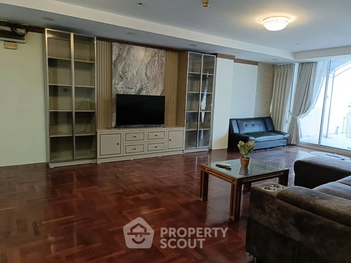 Spacious living room with elegant hardwood floors and modern furnishings