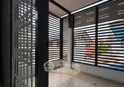 Spacious balcony with modern slatted design offering privacy and natural light, perfect for relaxation.