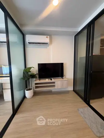 Modern living room with sleek glass partitions and stylish decor