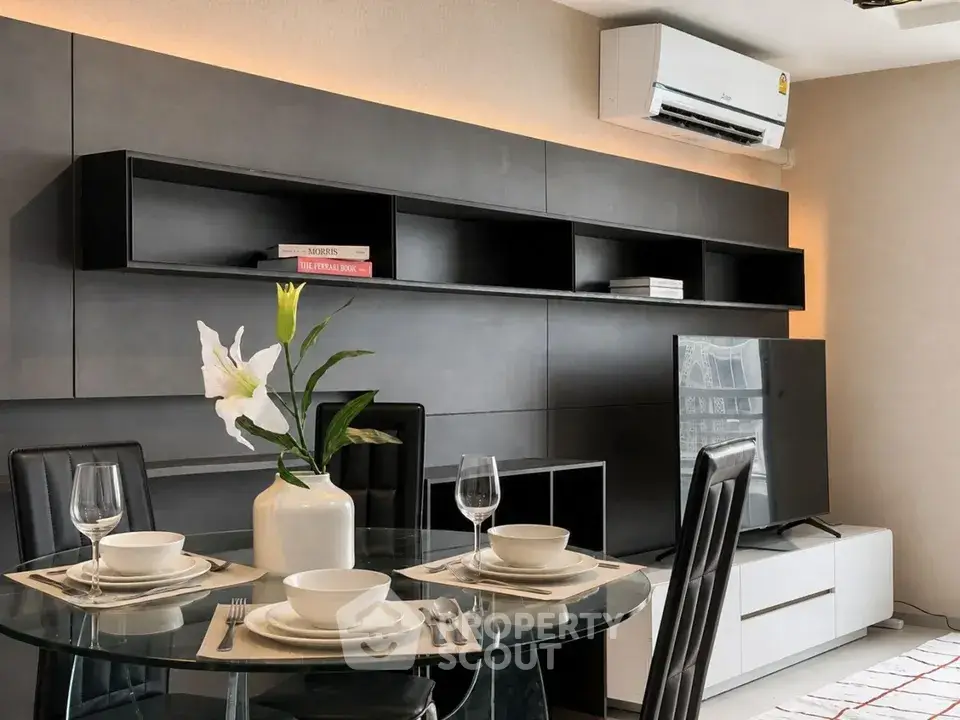 Modern living room with sleek furniture and dining setup, featuring a wall-mounted air conditioner and stylish decor.