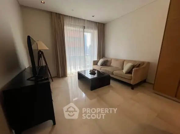 Elegant living room with modern sofa and large window, perfect for relaxation.