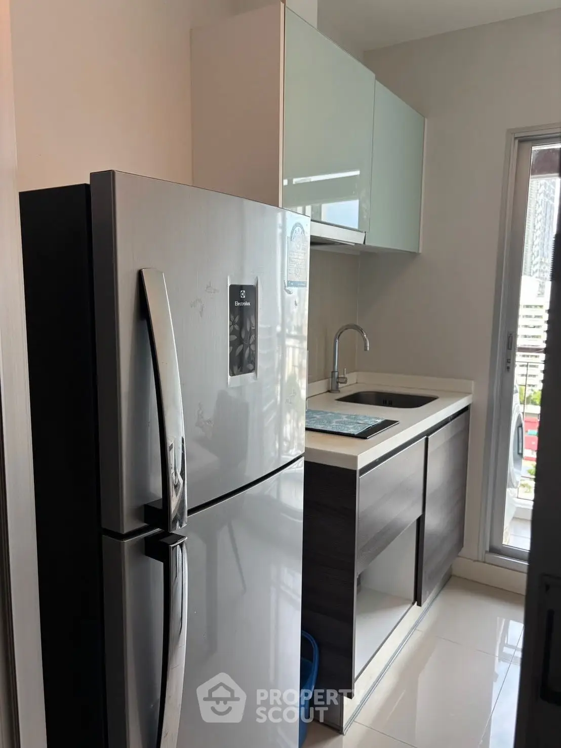 Modern kitchen with sleek fridge and minimalist cabinetry