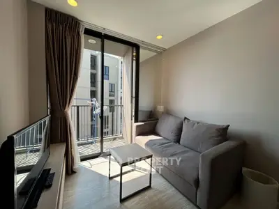 Modern living room with balcony access and natural light