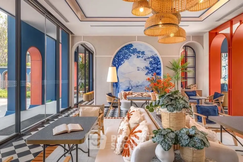 Stylish modern living room with vibrant decor and large windows, perfect for relaxation and entertaining.