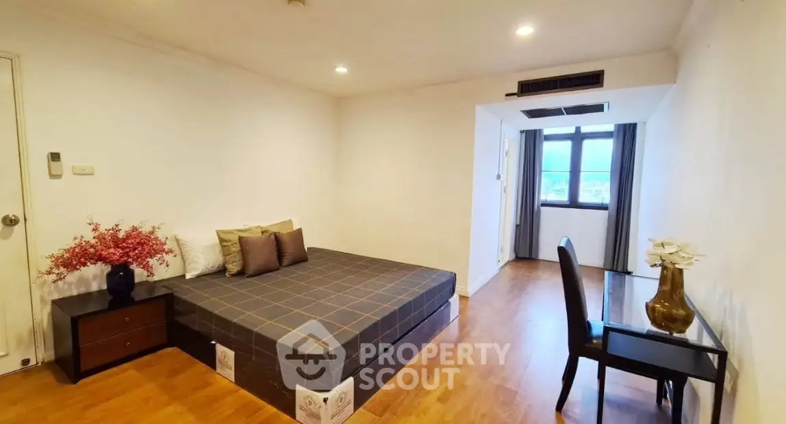 Spacious bedroom with modern decor and large window view