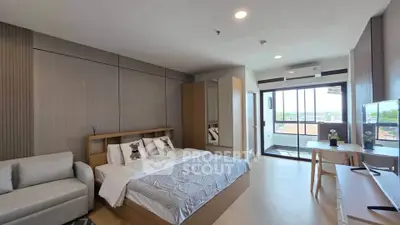Modern bedroom with balcony view, featuring stylish decor and ample natural light.