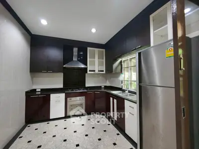 Modern kitchen with sleek cabinetry, stainless steel appliances, and elegant tile flooring.