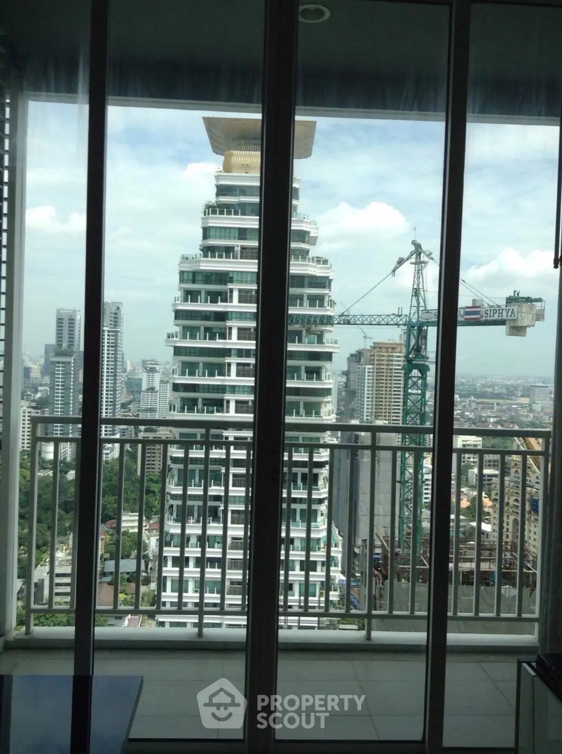 Stunning cityscape view from a high-rise balcony with modern architecture.