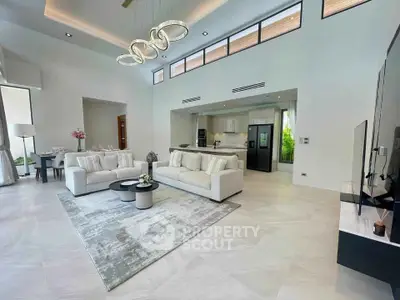 Luxurious open-plan living room with modern kitchen and elegant decor