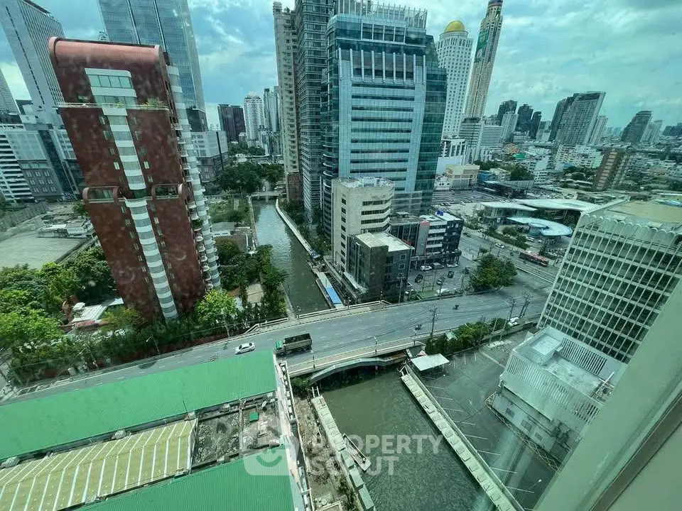 Stunning cityscape view from high-rise building overlooking urban skyline and canal.