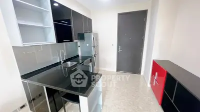 Modern kitchen with sleek black countertops and stainless steel appliances