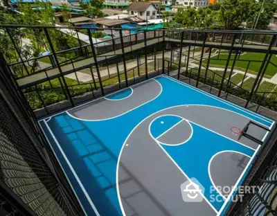 Modern apartment complex with rooftop basketball court and scenic city views.